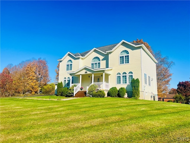 view of front of house featuring a front yard and covered porch