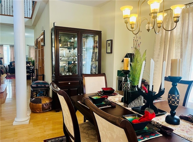 dining room with light hardwood / wood-style floors and an inviting chandelier