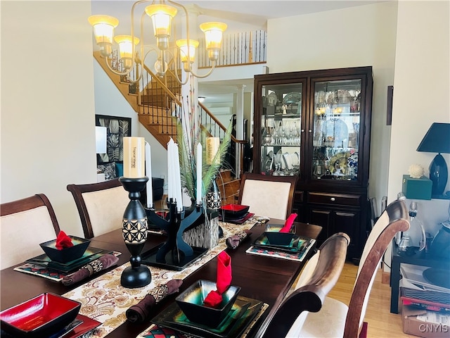 dining room with light hardwood / wood-style floors and a chandelier