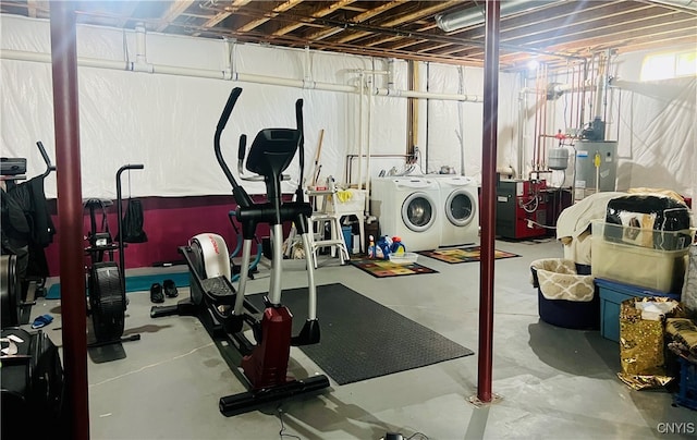 exercise room featuring water heater and separate washer and dryer