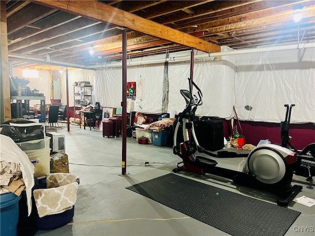 exercise room with electric panel and concrete flooring