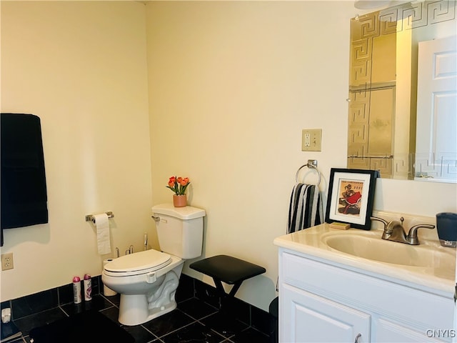 bathroom featuring vanity, toilet, and tile patterned flooring