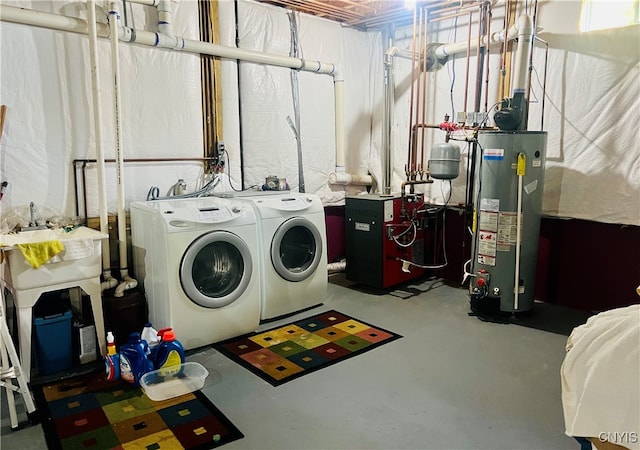 washroom with water heater, sink, and separate washer and dryer