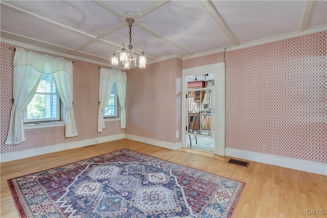 dining area featuring wood finished floors, visible vents, and wallpapered walls