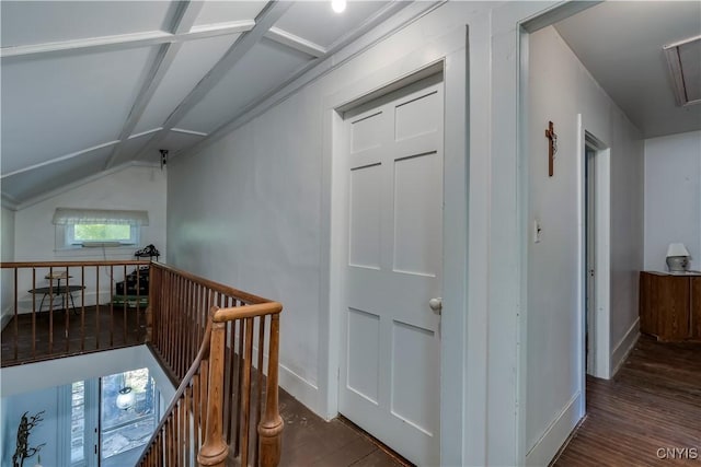 corridor with baseboards, vaulted ceiling, wood finished floors, and an upstairs landing