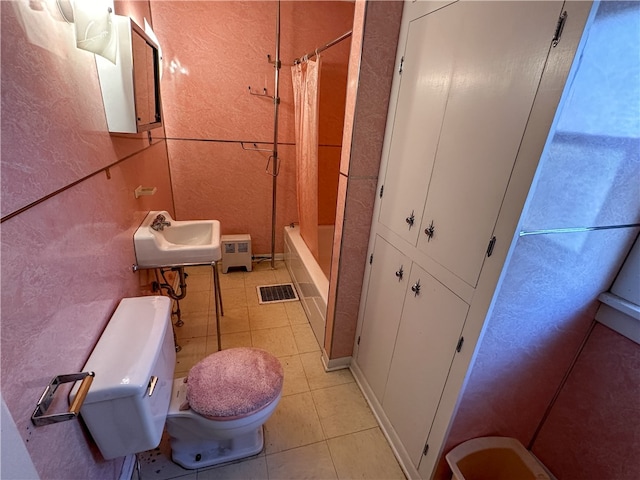 full bathroom with tile patterned floors, toilet, sink, and shower / bath combo with shower curtain