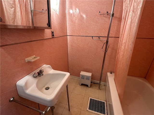 bathroom with tile patterned floors, sink, and shower / tub combo