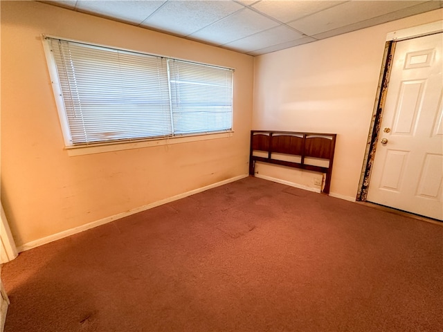 spare room with a drop ceiling and carpet floors