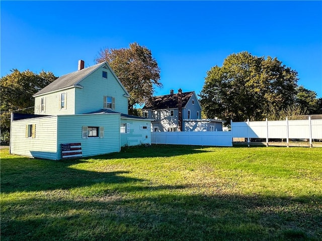 back of house featuring a lawn