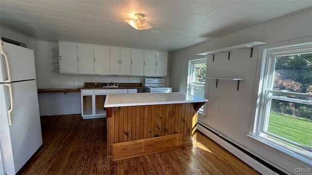 kitchen featuring dark hardwood / wood-style floors, tile countertops, baseboard heating, white cabinetry, and white appliances