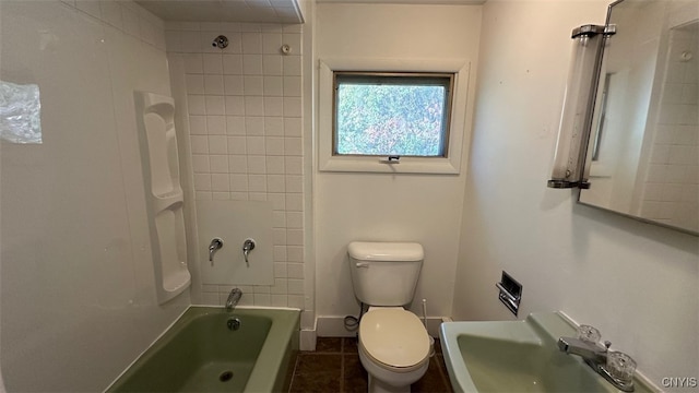 full bathroom featuring toilet, tiled shower / bath combo, sink, and tile patterned flooring