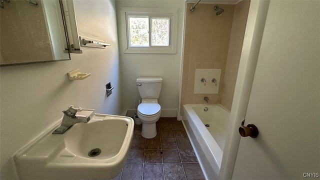 full bathroom featuring tiled shower / bath, sink, and toilet