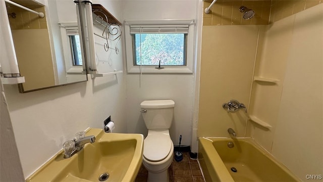 full bathroom with toilet, tiled shower / bath combo, sink, and tile patterned flooring