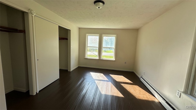 unfurnished bedroom featuring a textured ceiling, dark wood-type flooring, and a baseboard radiator