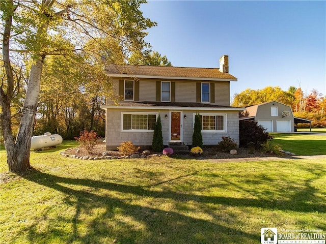 traditional-style home featuring an outbuilding, a chimney, a detached garage, and a front yard