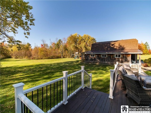 deck with an outdoor structure, a playground, and a yard