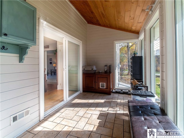 unfurnished sunroom featuring visible vents, wooden ceiling, and vaulted ceiling