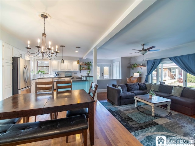 dining room featuring french doors, wood-type flooring, and ceiling fan with notable chandelier