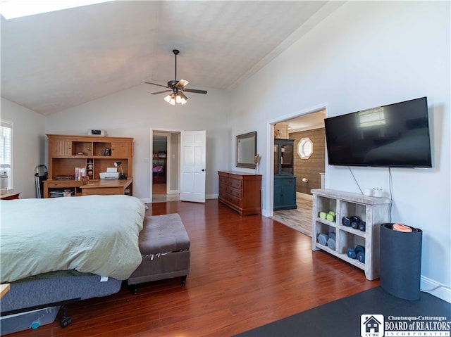 bedroom with lofted ceiling, dark wood-type flooring, connected bathroom, and ceiling fan