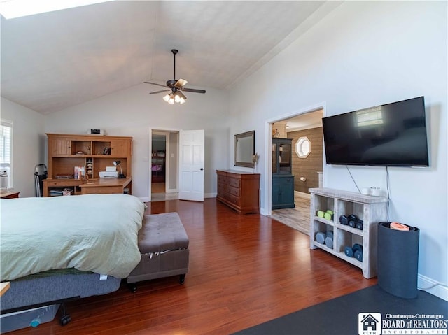 bedroom featuring high vaulted ceiling, ensuite bathroom, baseboards, and wood finished floors