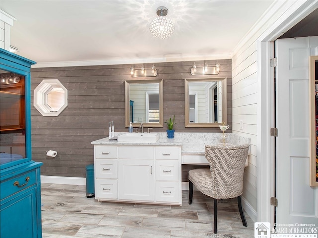 bathroom with vanity, crown molding, and wood-type flooring