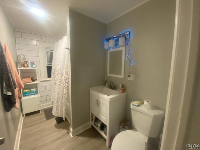 full bathroom featuring toilet, shower / bathtub combination with curtain, vanity, and wood-type flooring