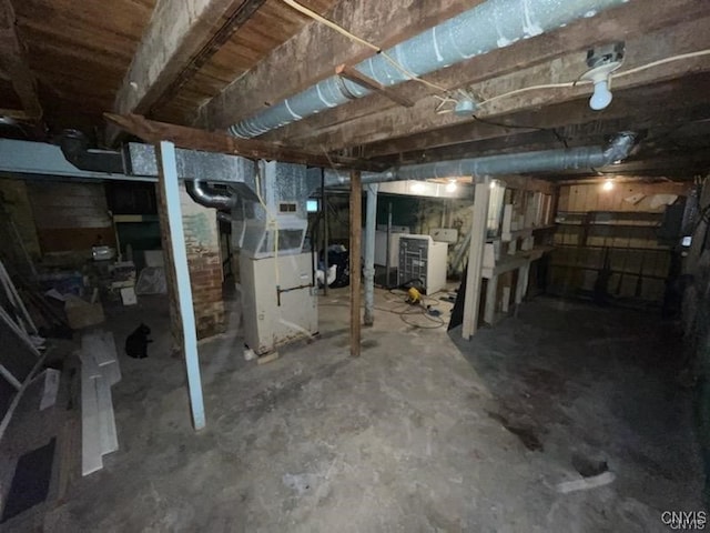 basement with heating unit and separate washer and dryer