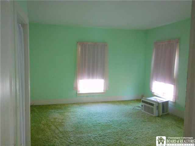 empty room featuring light carpet and cooling unit