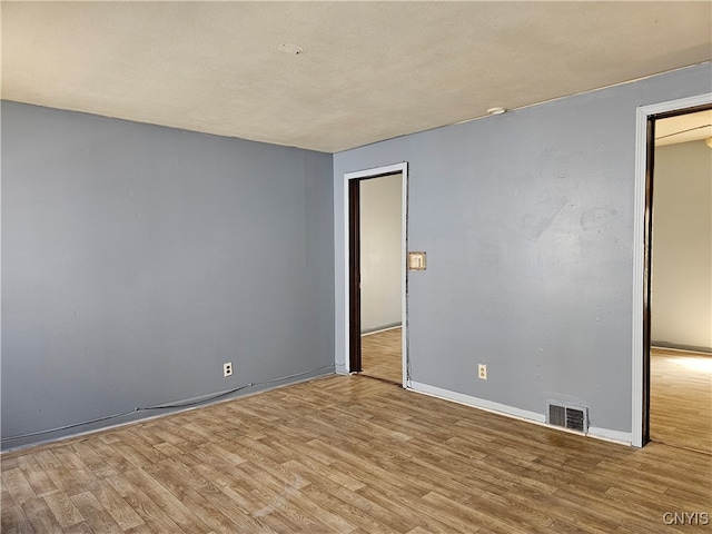 spare room with light wood-type flooring