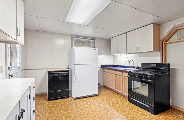 kitchen featuring white cabinetry, a paneled ceiling, black appliances, and sink