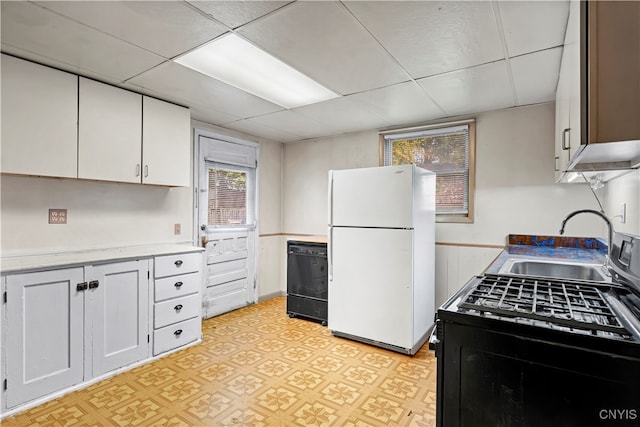 kitchen featuring a drop ceiling, white cabinets, black appliances, and sink