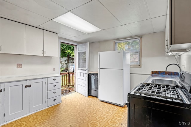 kitchen featuring white fridge, black dishwasher, a wealth of natural light, and white cabinets