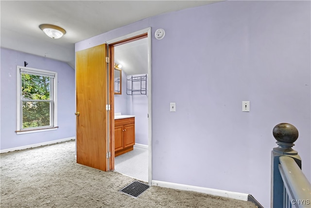 hallway with light colored carpet