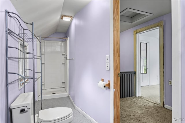 bathroom featuring lofted ceiling, a shower, and toilet