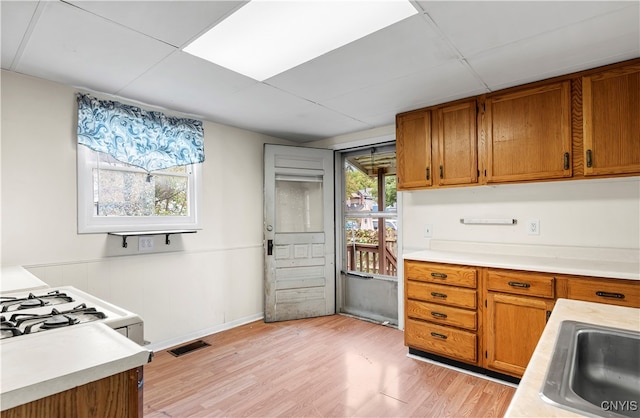 kitchen with white gas stove and light wood-type flooring