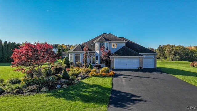 view of front of house with a front lawn and a garage