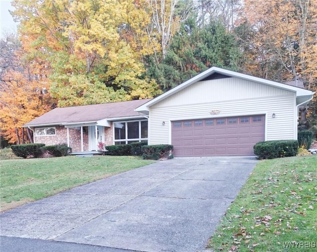 ranch-style house with an attached garage, a front lawn, and concrete driveway