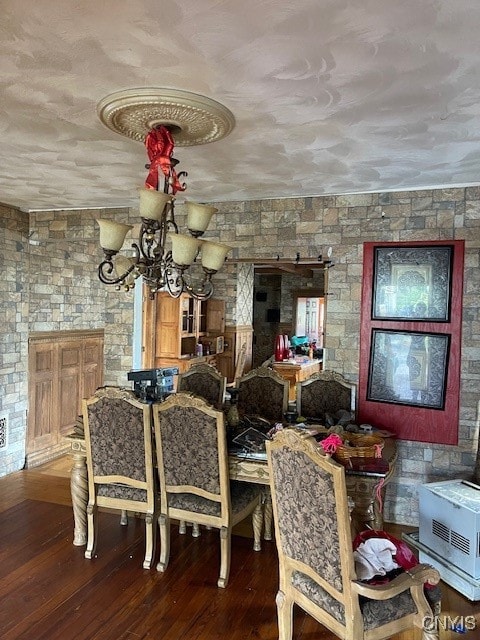 dining space with a notable chandelier and wood-type flooring