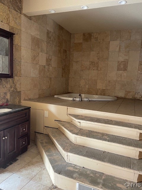 bathroom featuring tile walls, vanity, and tile patterned flooring