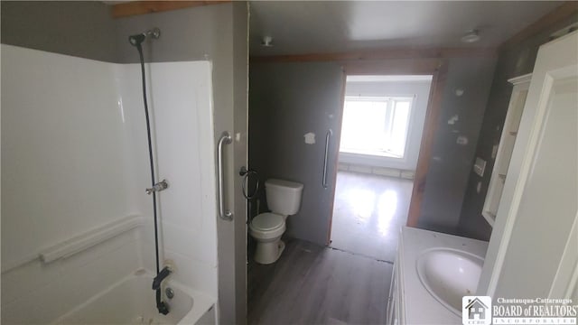 full bathroom featuring  shower combination, vanity, hardwood / wood-style flooring, and toilet