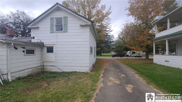 view of property exterior with a lawn