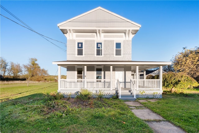 view of front facade with a front lawn and covered porch