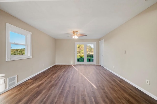 empty room featuring ceiling fan and dark hardwood / wood-style floors