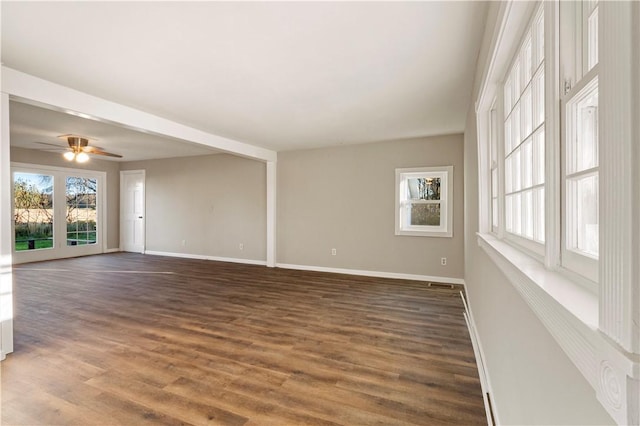 empty room featuring dark wood-type flooring and ceiling fan