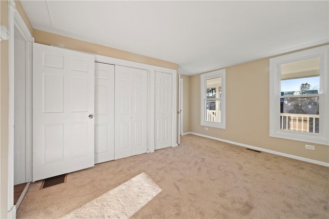 unfurnished bedroom with light carpet