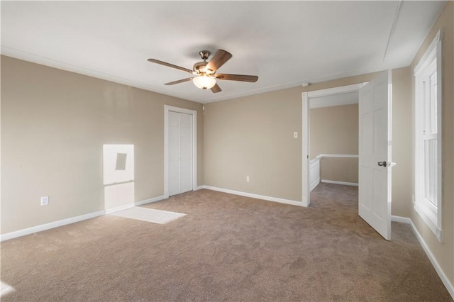 unfurnished bedroom with ceiling fan and carpet