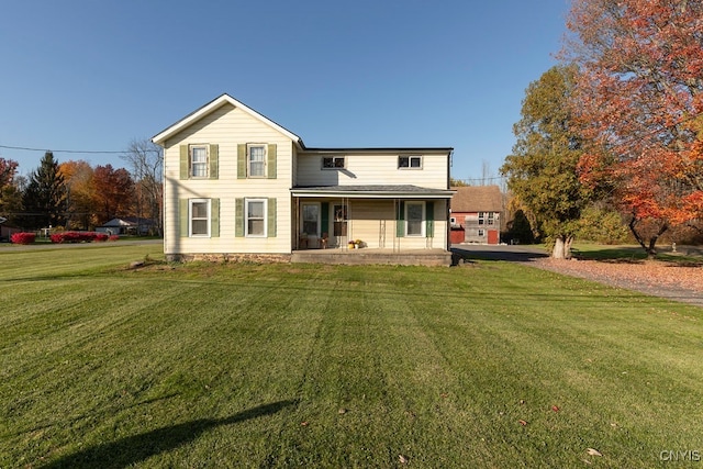 rear view of house with a yard