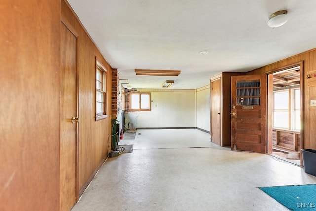 spare room featuring wood walls