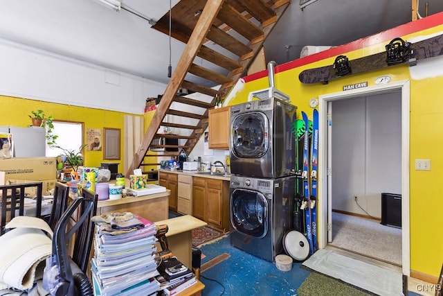 interior space with stacked washer / drying machine, sink, and dishwasher