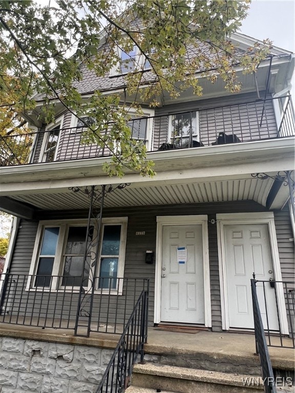 view of front of house featuring covered porch and a balcony